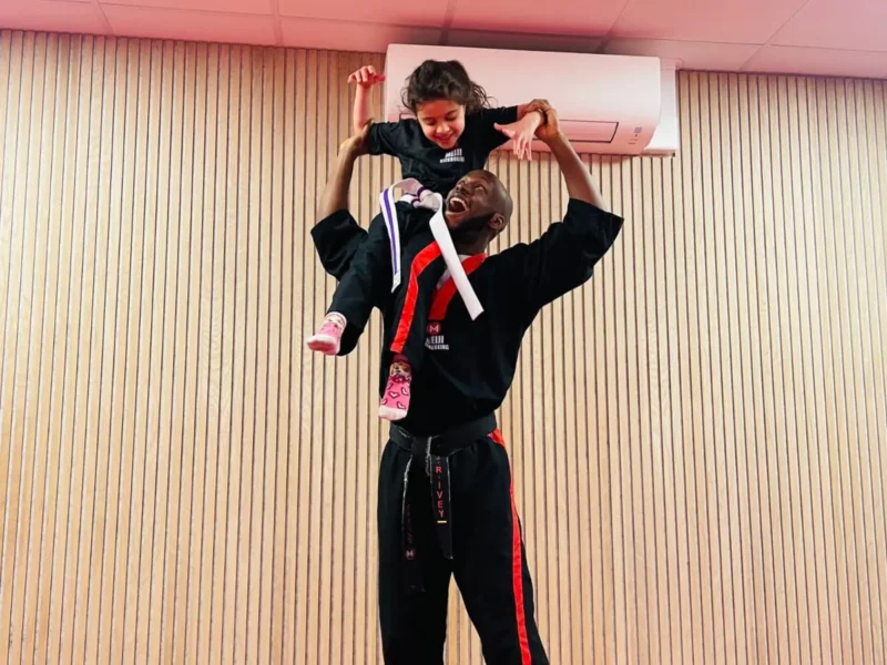 Sensie Josh holding up a student